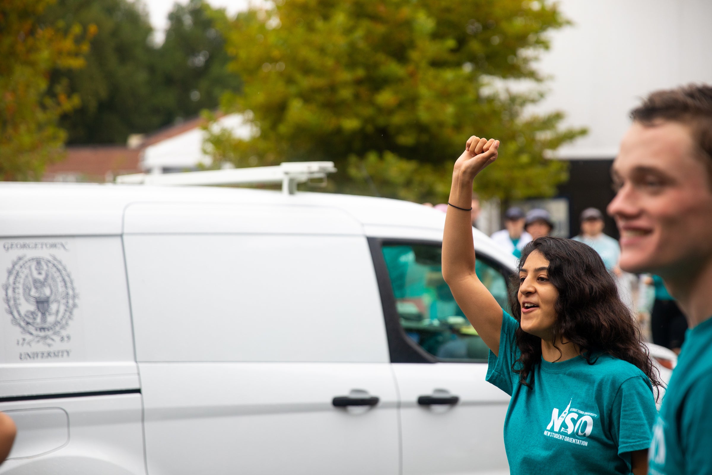 two students wave