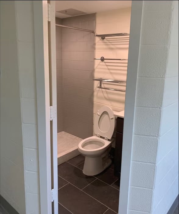 bathroom with toilet and standing shower