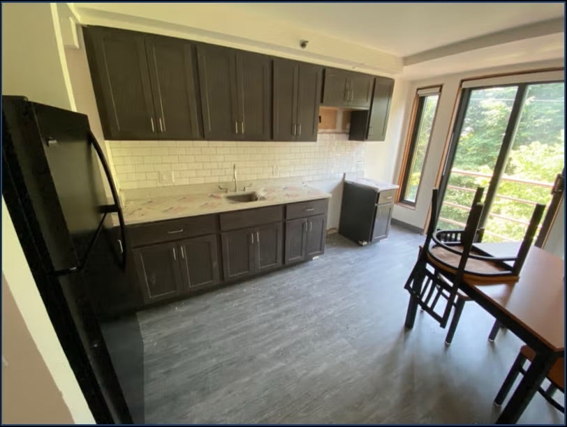 kitchen with black cabinets and kitchen table