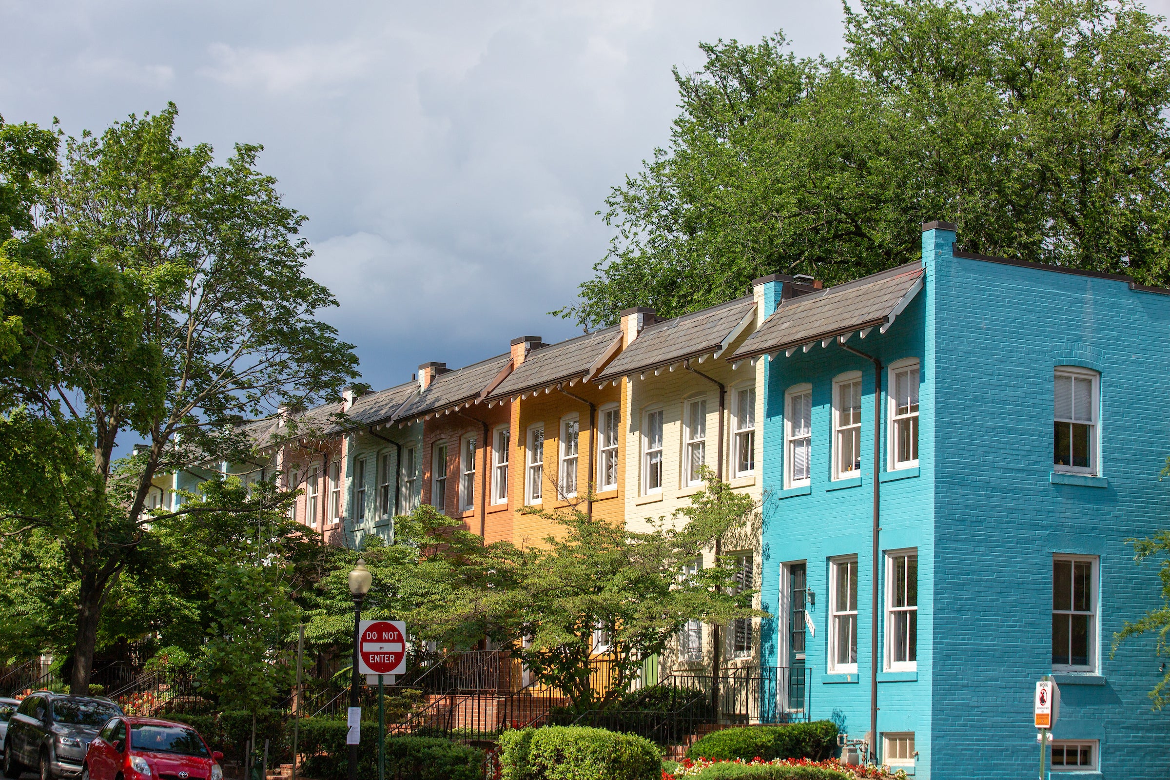 colorful townhouses surrounded by trees
