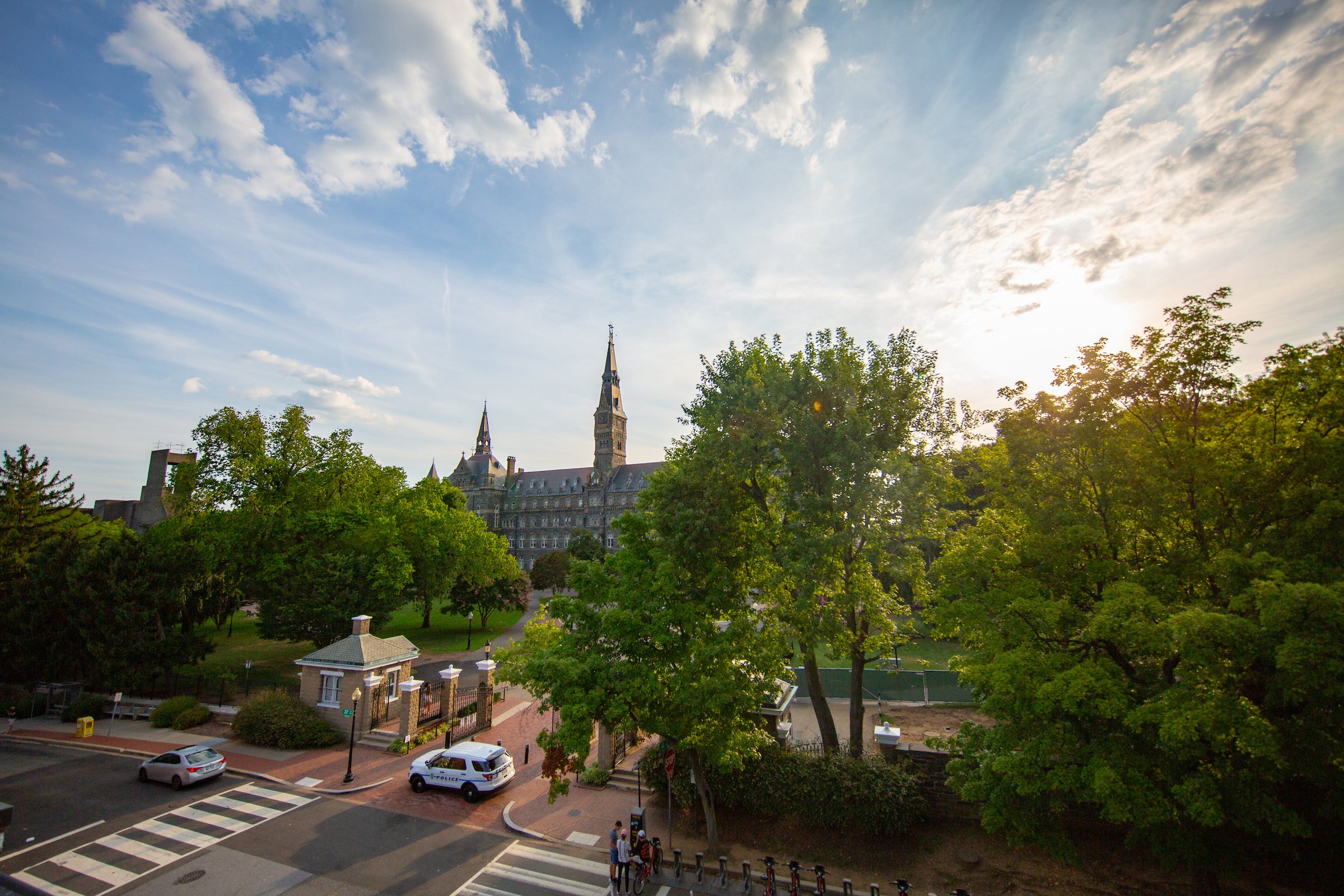 view of Hilltop campus at sunrise with Healy hall and trees