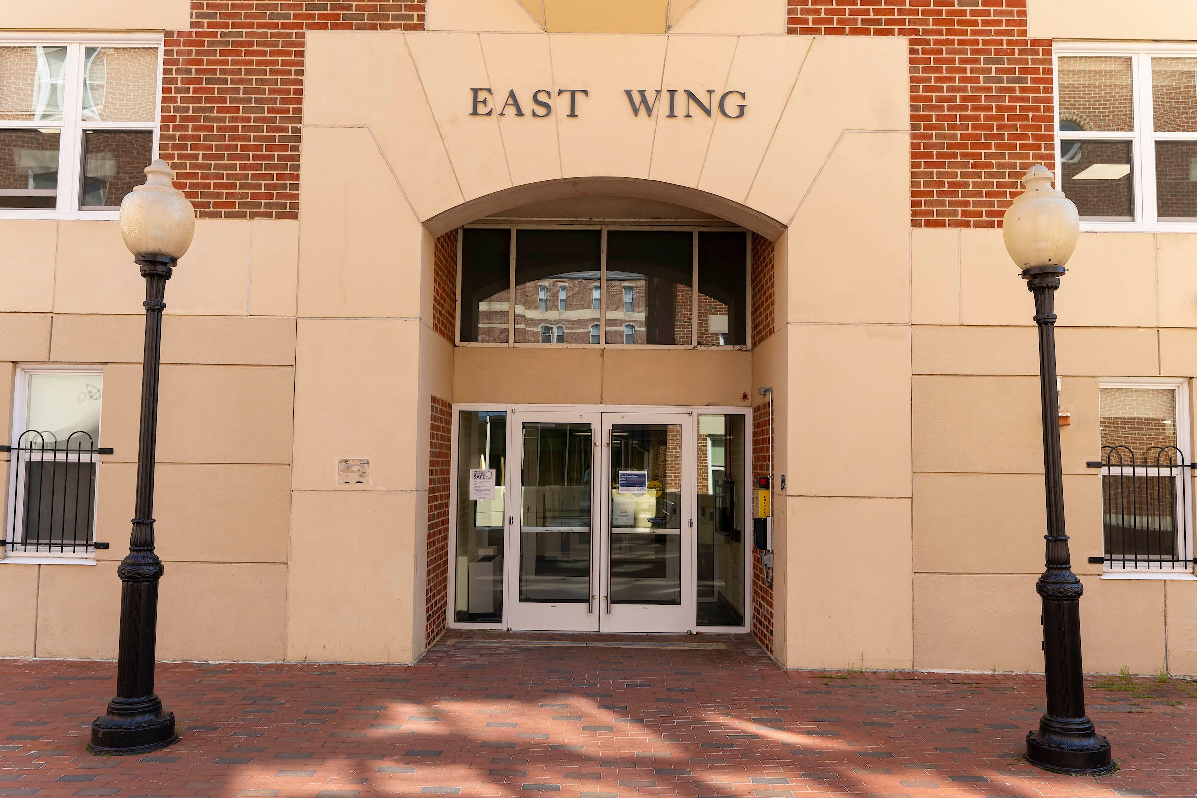 light colored brick building entrance that reads 