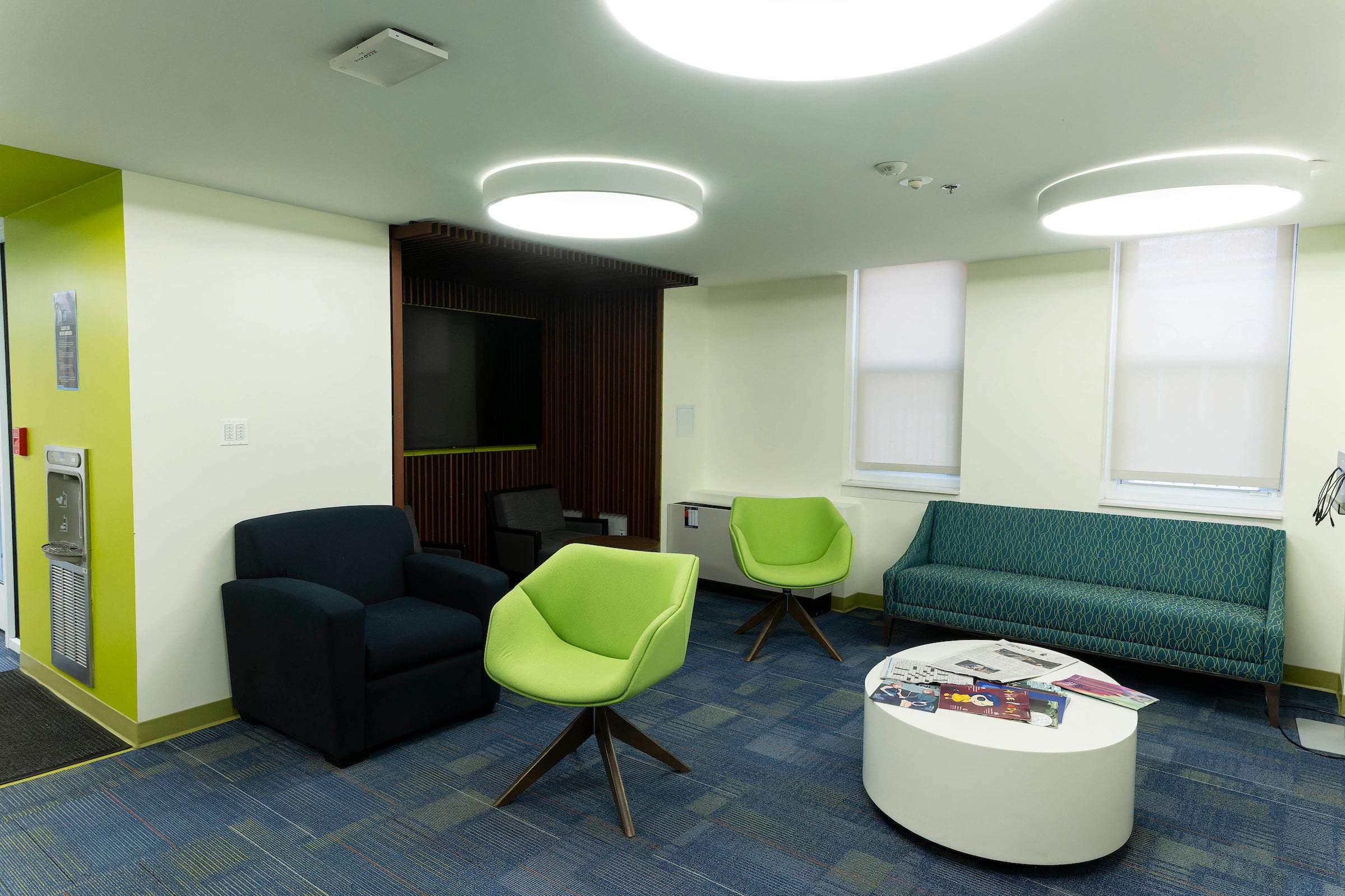Common area with brightly colors blue and green furniture