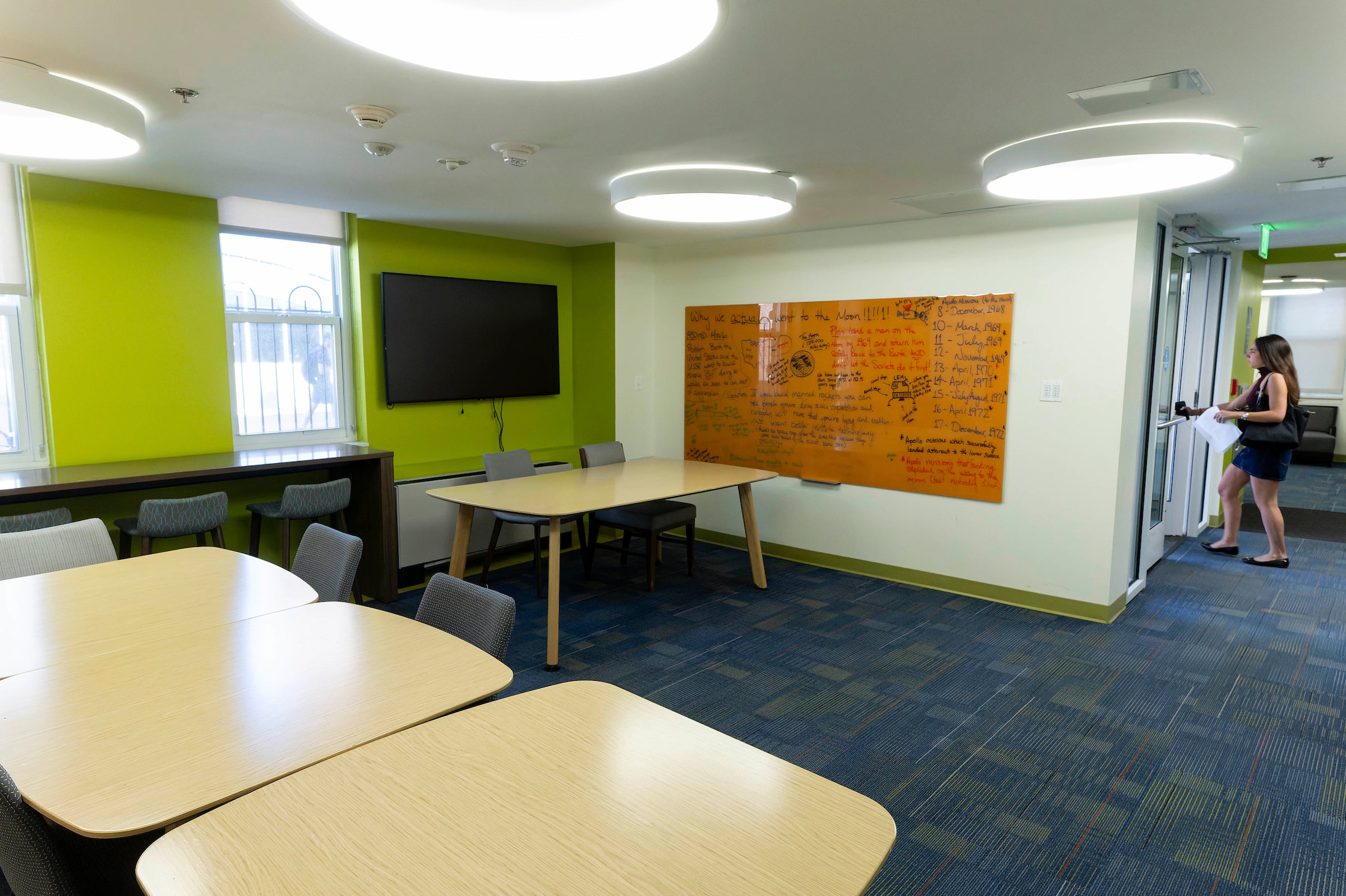 common area with furniture, whiteboards, and TV