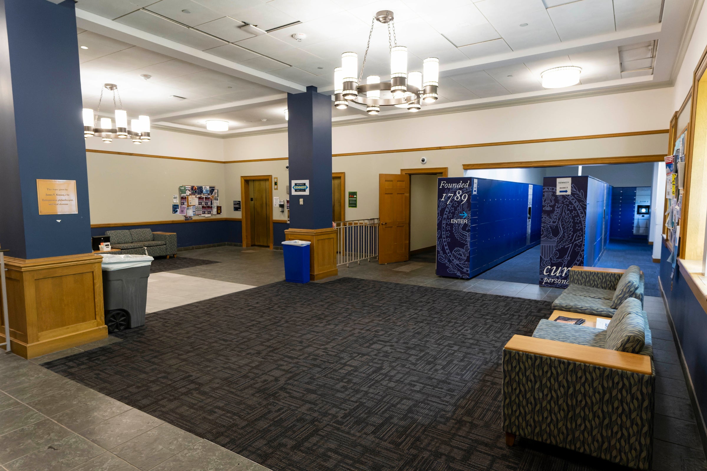 Lobby with carpet, chairs, and blue Amazon lockers