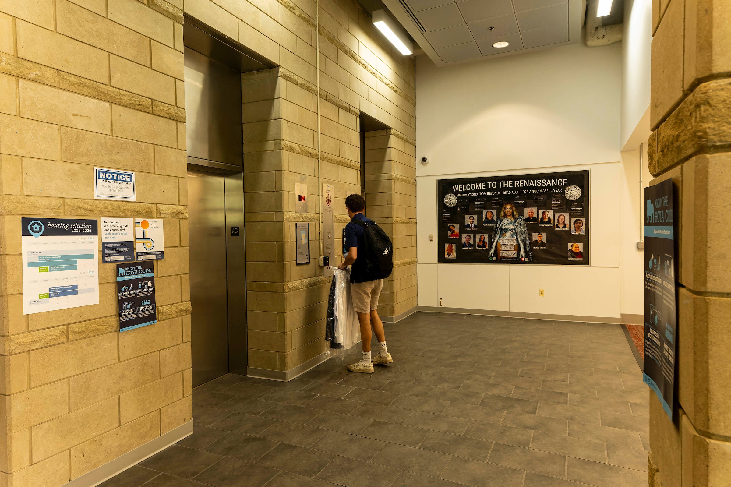 stone elevator bank with a student boarding