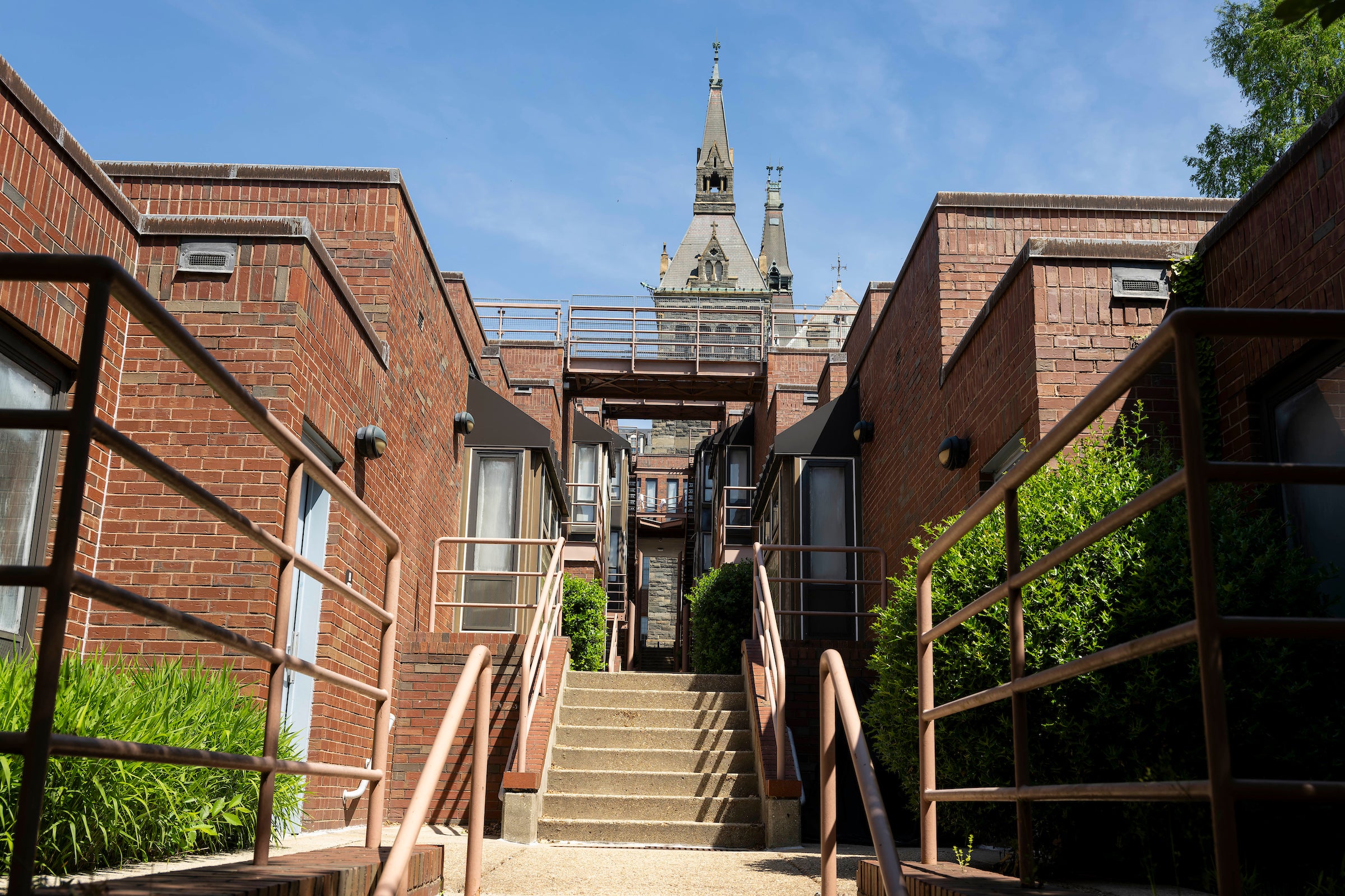 brick apartment buildings divided by exterior stairway