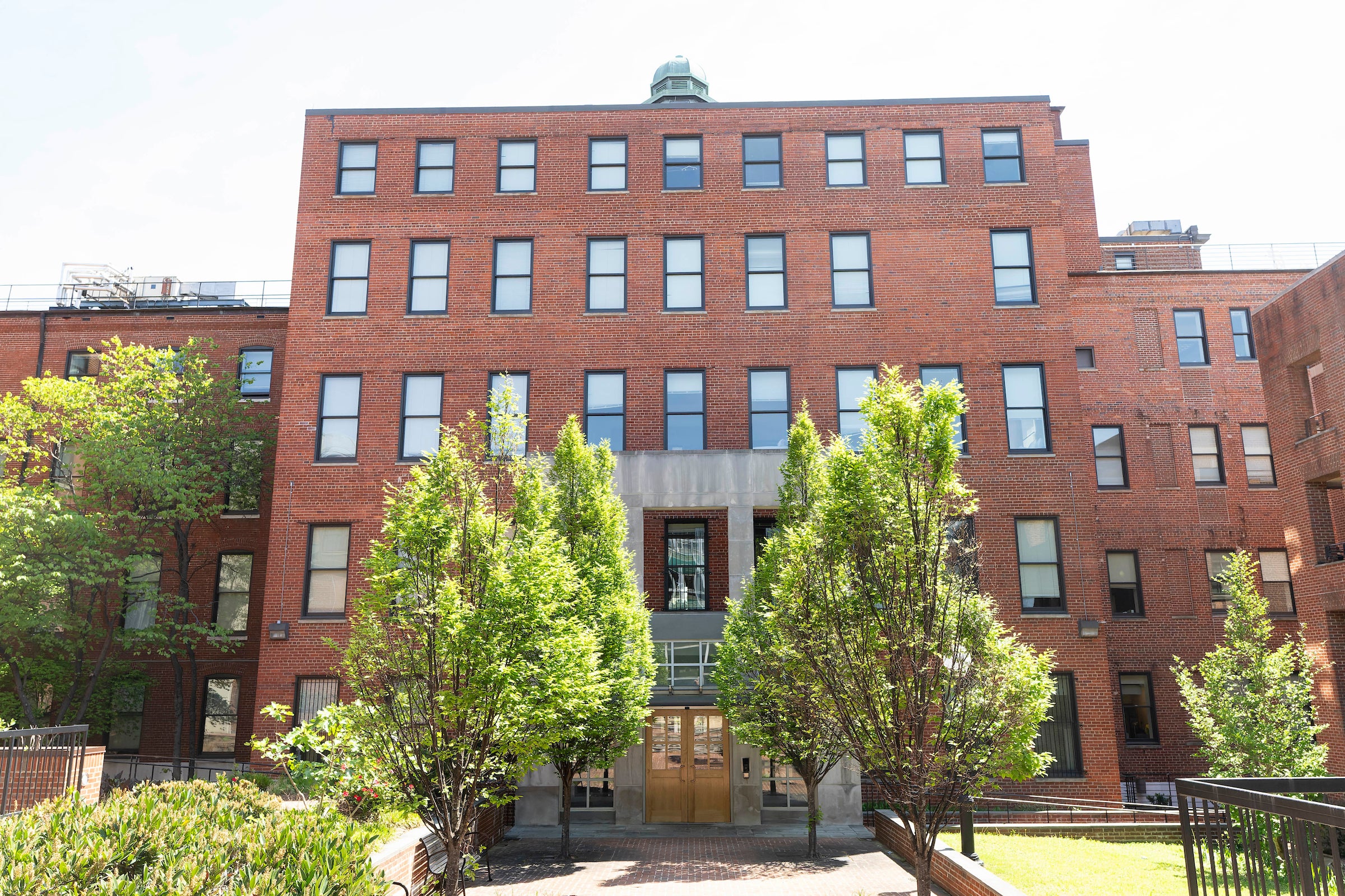 brick building with trees and quad entrance