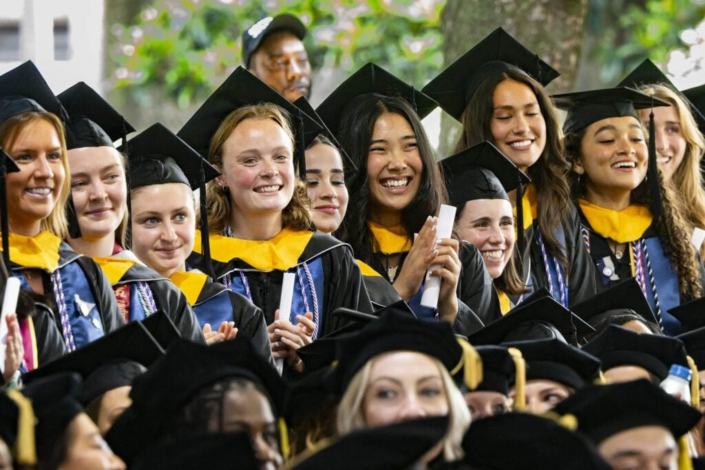 students in rows in caps and gowns